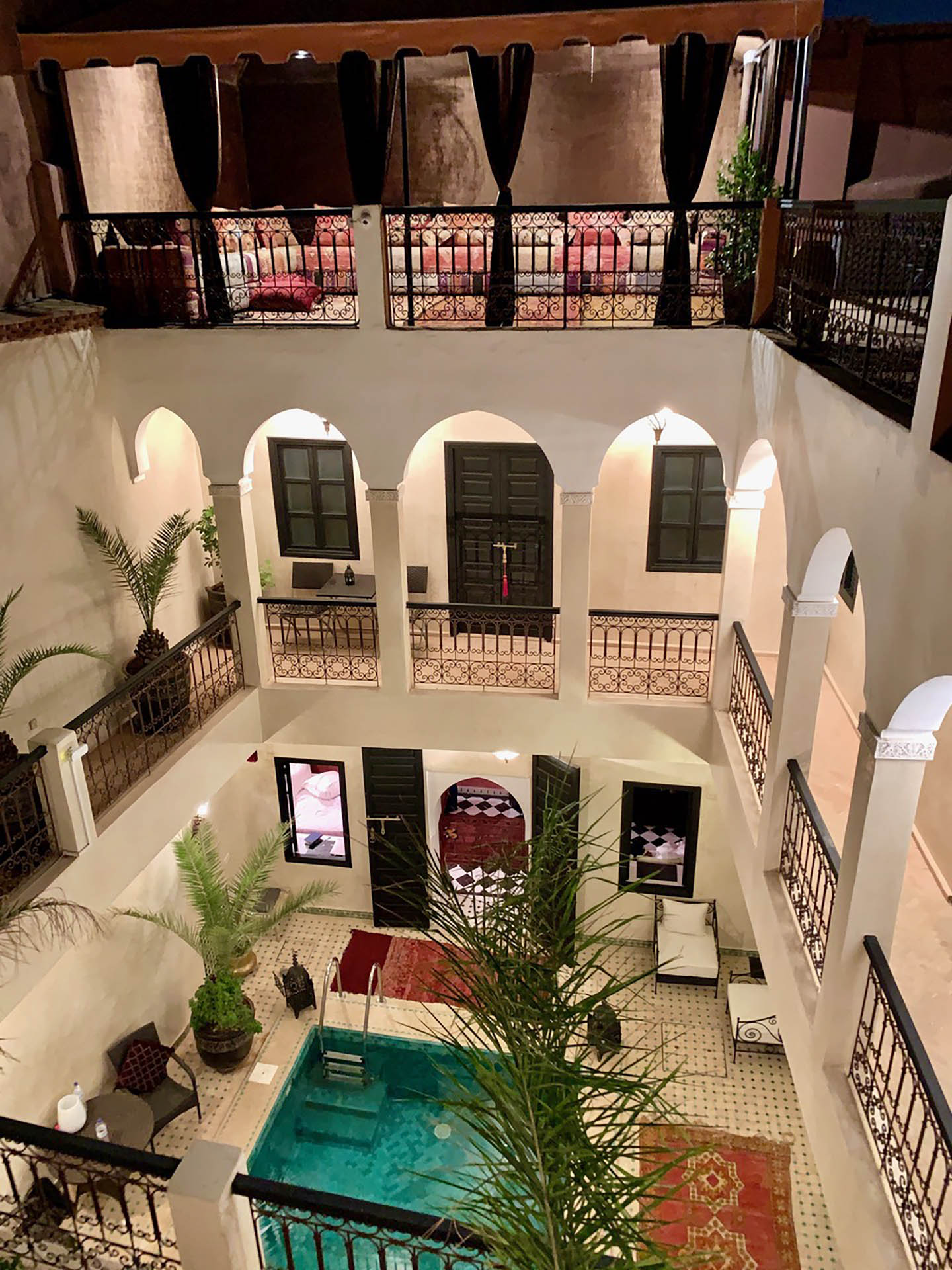 Riad Baya, view of interior courtyard with pool from upper level evening